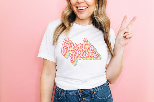 a woman wearing a t - shirt that says first grade