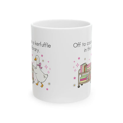 A white ceramic mug with a playful design featuring a duck and a library scene.