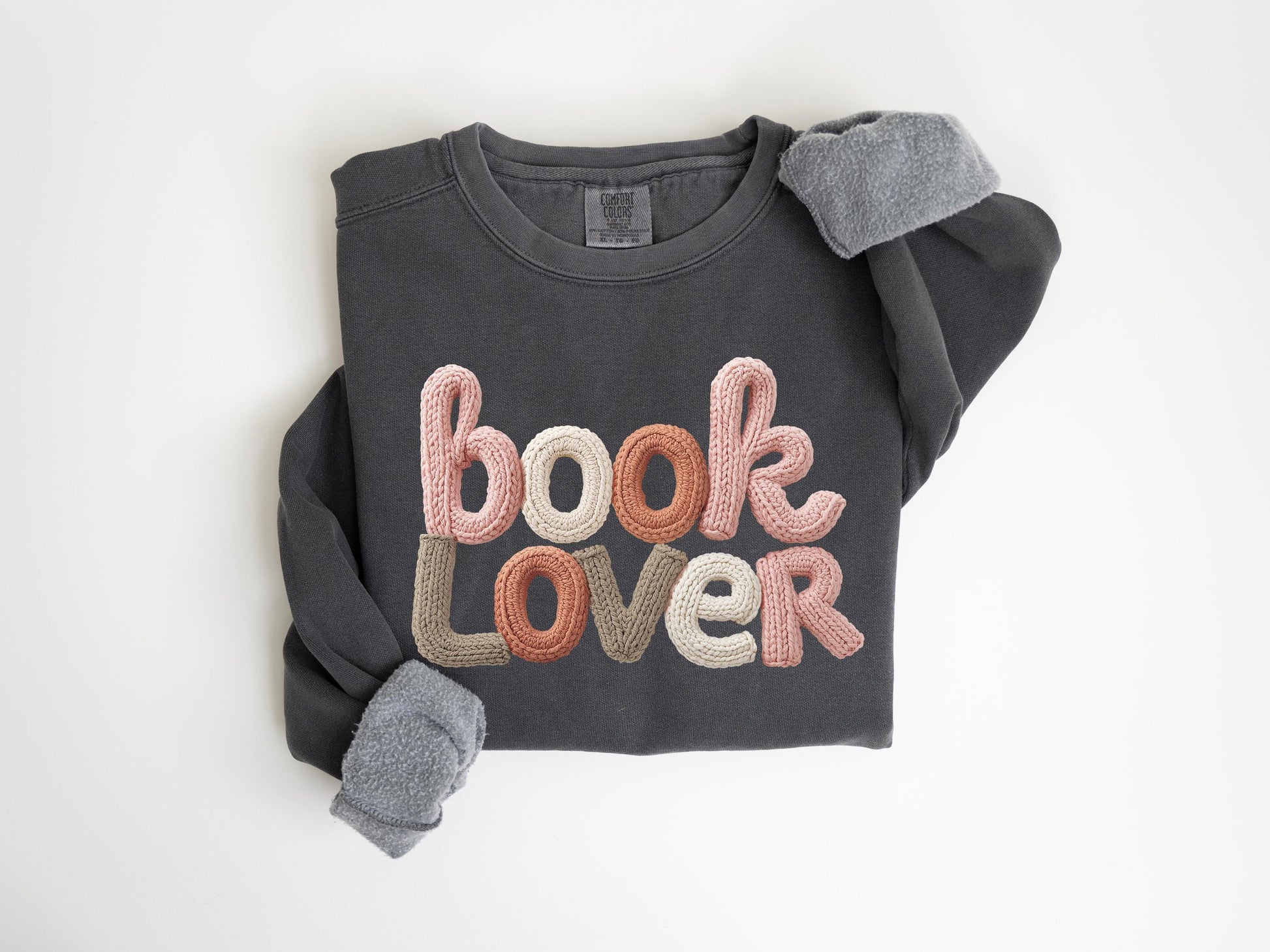 A gray sweatshirt with the text "book Lover" embroidered on it.