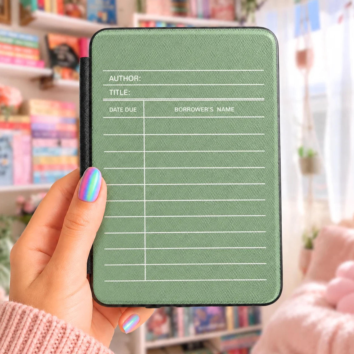 A person's hand holding a green book-shaped e-reader with a white grid-like pattern on the cover.