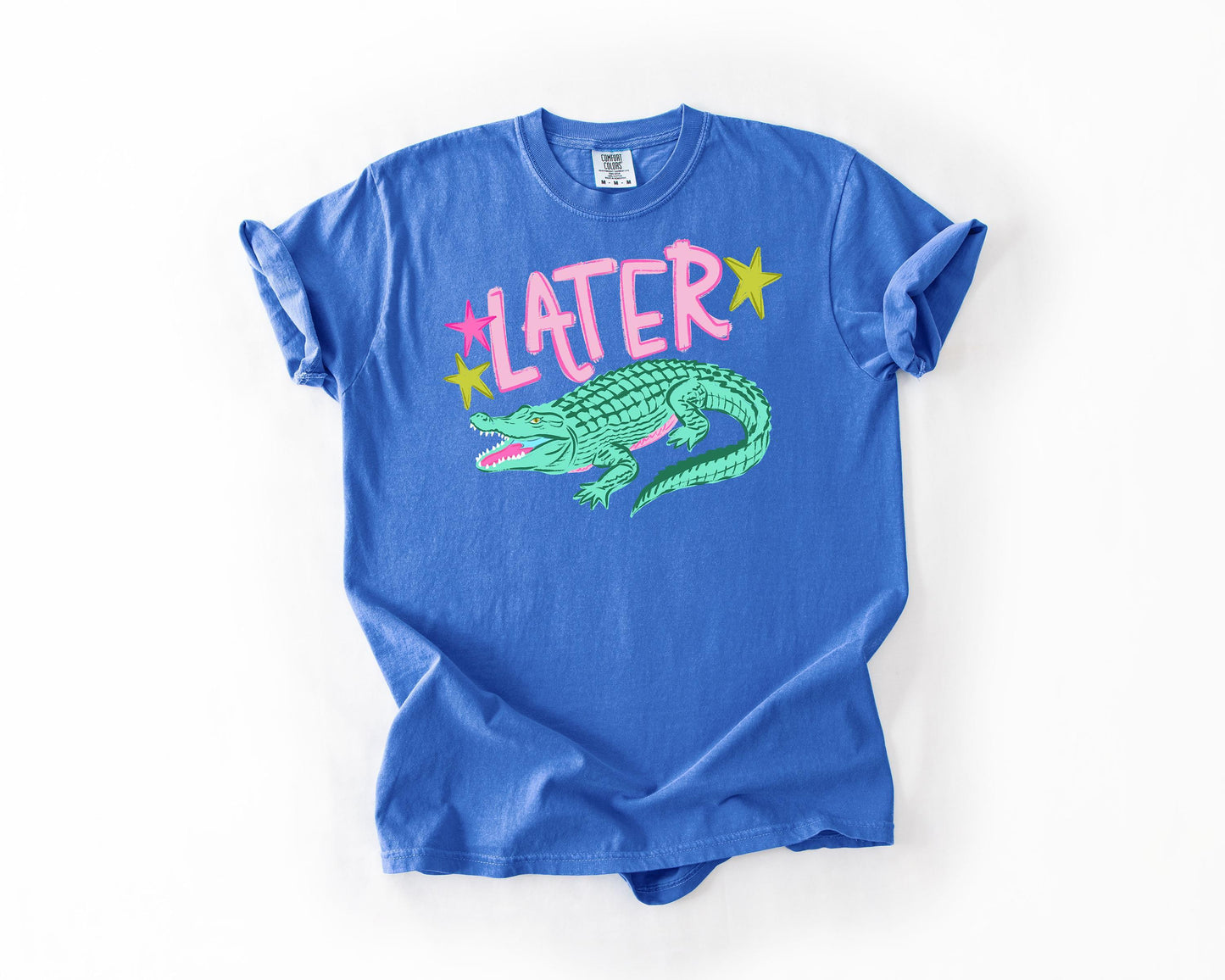 A blue t-shirt with a graphic of a green alligator and the word "later" printed on it.