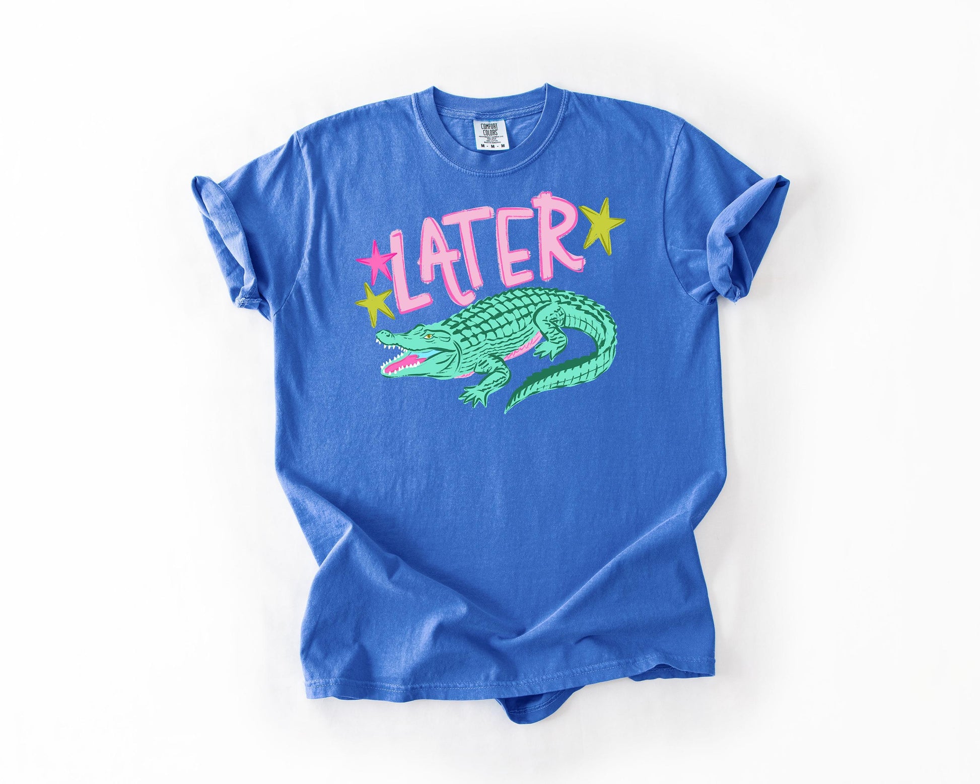 A blue t-shirt with a graphic of a green alligator and the word "later" printed on it.