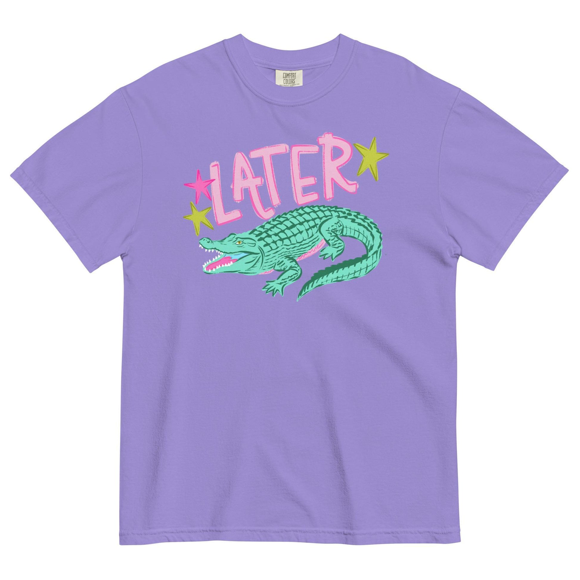 A purple t-shirt with a graphic design featuring a green alligator and the word "later" written above it.