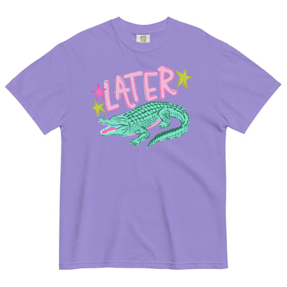 A purple t-shirt with a graphic design featuring a green alligator and the word "later" written above it.