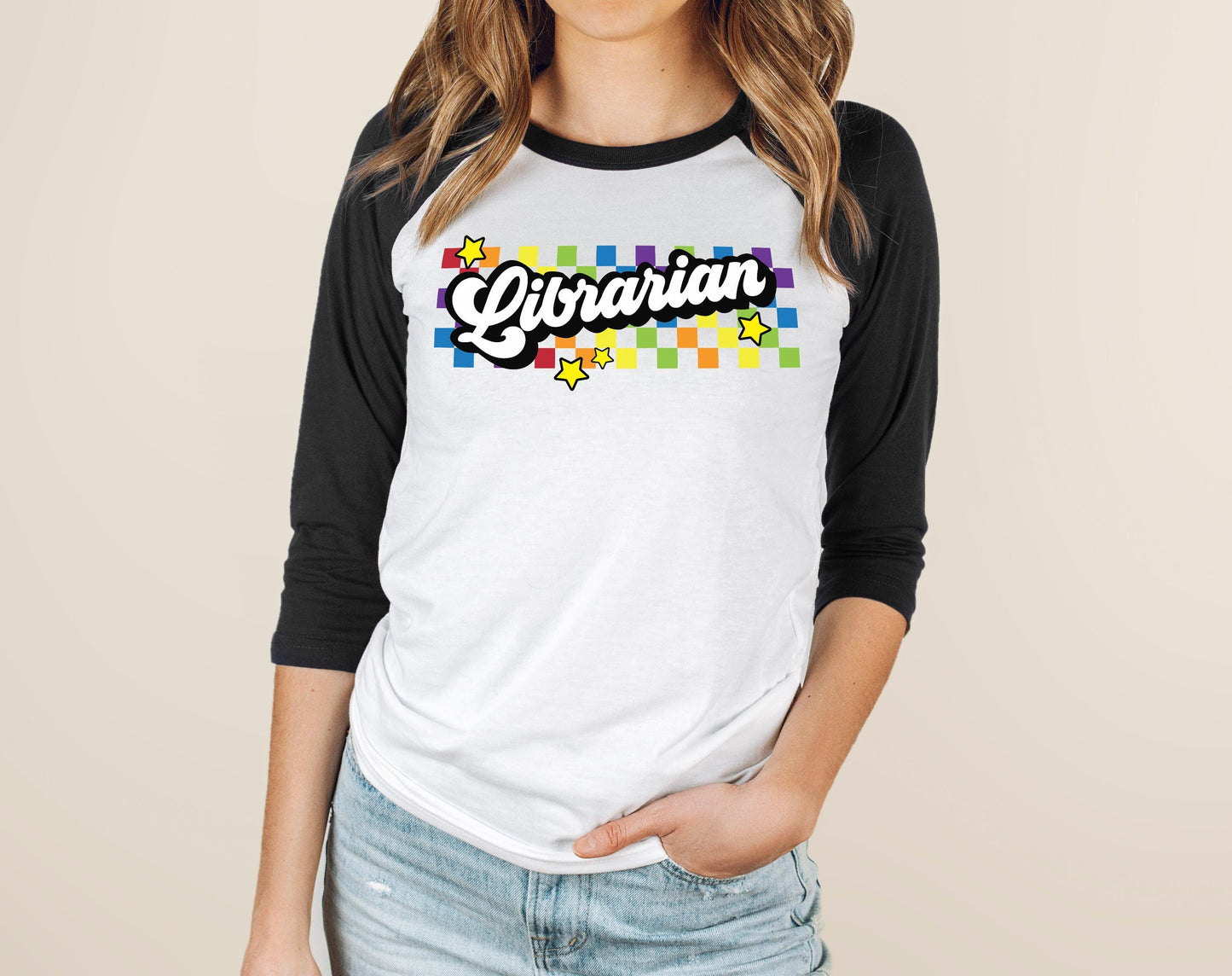 A woman wearing a white and black baseball tee with the word "Librarian" printed on it.