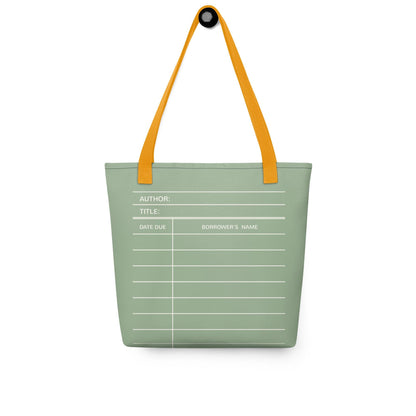 A green tote bag with a white library card design printed on it.