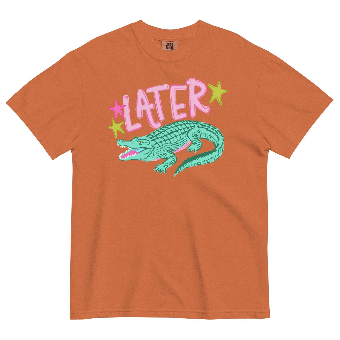 An orange t-shirt with a graphic design featuring a green alligator and the word "later" written above it.